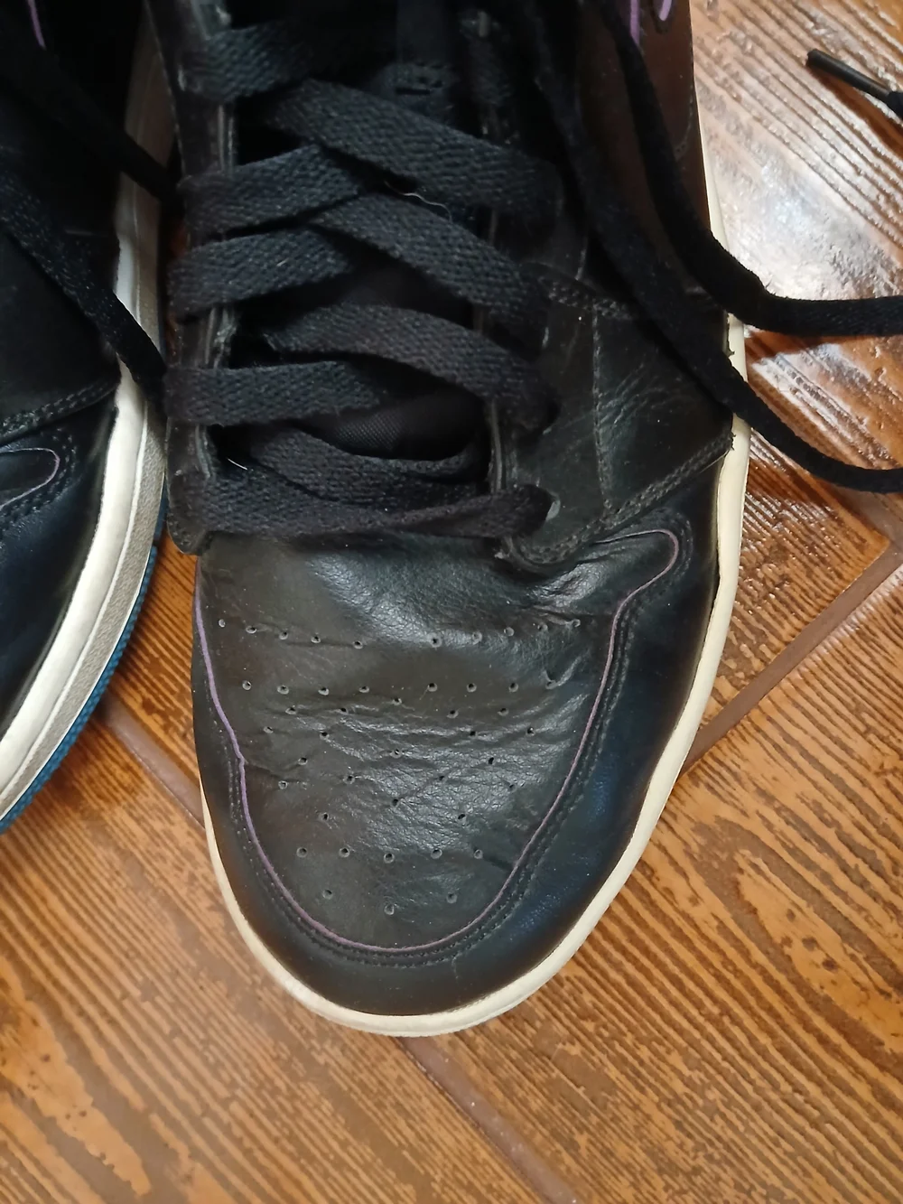 Classic Air Jordan high tops. Black with pink wing logo and blue
